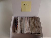 Top view of box filled with vertically stacked hockey cards showing the thickness and quantity of cards in the lot