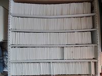 Five rows of hockey cards individually sleeved in white sleeves inside a storage box.