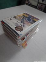 Stack of Mark Messier hockey cards in penny sleeves seen from an angle showing the front card with Mark Messier in blue hockey jersey.