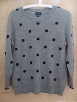 Front view of grey J.Crew cashmere sweater with black polka dots, showing overall condition and design.
