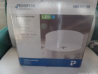 Box of Progress Lighting flushmount LED ceiling light with product details and image of the fixture