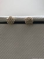 Front view of the small round pave diamond flat-back piercing studs showing diamond cluster on gold base.