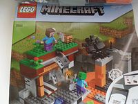 Photo of LEGO Minecraft set box art showing number 21166 with Minecraft characters and landscape.