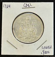 Reverse side of the 1964 Canadian 50 cent silver coin showing the Canadian coat of arms and the year 1964.