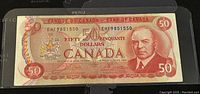 Front side of 1975 Canadian 50 dollar banknote showing portrait and denomination.