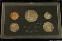 Front side of the 1983 US proof coin set showing Lincoln cent, Jefferson nickel, Roosevelt dime, Washington quarter, and Kennedy half dollar coins in proof condition.