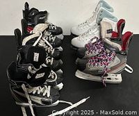 Five pairs of assorted ice skates arranged in two rows showing different styles and sizes