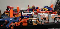 Wide layout of all Nerf blasters showing various series and magazines included