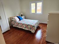 Twin size IKEA wooden bed frame set up with mattress and bedding for context, showing natural light wood color and simple frame design.