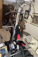 Front-angle view of entire Bowflex home gym with bench, frame and lat bar attached