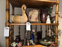 Shelf with large swan figurine, framed artwork, various glass and ceramic figurines and vases