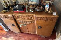 Front view of credenza with decorative items on top