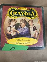 Front of the Crayola collector tin showing vintage artwork and Crayola branding