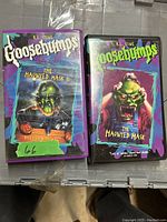Photo of Goosebumps The Haunted Mask II VHS tape with original sleeve and plastic case, showing front artwork with green monster mask and pumpkin.