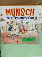 Photo of the front cover of 'Munsch Mini-Treasury One' children's book showing colorful illustrations and title.