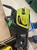 Side view of Poulan chainsaw showing yellow label with model 346 and 16 inch bar length indicated.