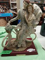 Front view of porcelain couple figurine mounted on wooden base with Via Veneto Collection plaque.