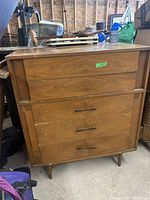 Full view of the vintage wooden dresser showing drawer layout and tapered legs.