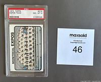 Front side of 1973 Topps Montreal Expos Team baseball card, showing team photo within PSA holder and maxsold lot number card.