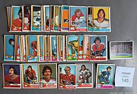 Flat lay of multiple 1974-75 O.P.C. hockey cards showing player images with colorful borders.