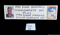 Long photo of handwritten label describing the lot as 1990 Score Baseball (1-704) complete set plus 1990 Score Traded (1-110) complete set