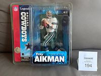 Front view of sealed 2005 Troy Aikman McFarlane NFL Legends Series figurine in packaging showing player and branding.