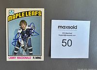 Front of the 1976-77 Lanny Macdonald hockey card showing player image and autograph in blue Sharpie.