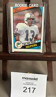 Front of the Dan Marino 1984 Topps Rookie Card #123 showing player image, team Dolphins, and rookie card label.