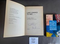 Title page of “Last Chance to See” showing author signature and paperback “The Hitchhiker’s Guide to the Galaxy” beside it