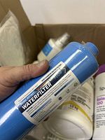 Close-up of blue water filter cartridge labeled 'Water Filter' model HWT-10A