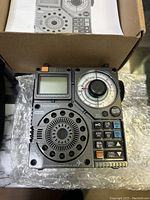 Photo of the HanRongDa HRD-A320 radio out of box showing the device and manual.