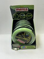 Front-view photo of seven rolls of glow in the dark Lego tape inside original retail display box, showing branding and product details.