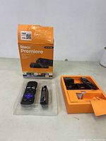 Roku Premiere box, remote control, power adapter, USB cable, and device off the tray on a white surface.