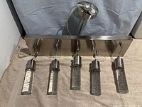 Front view of chrome base with five hanging clear bubble glass lights