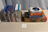 Photo showing collection of PS4, PS5, Wii and Wii U game cases alongside board games and puzzles on a table.