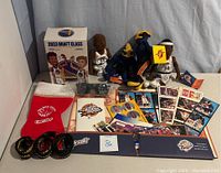 Full display of Golden State Warriors memorabilia and collectibles including dolls, mascot plush toys, mini basketballs, cards, holiday stocking, and 2023 Draft Class box.