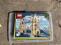 Instruction manual for Lego Tower of London set 10214 folded and displayed on plastic bin lid.