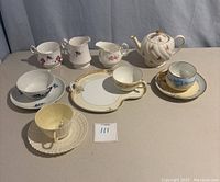 Photo shows entire lot arranged on beige surface with all items visible