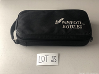 Closed zippered black carrying case showing Swiftlyte Boules embroidery.