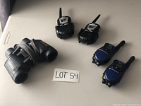 Photo of two pairs of walkie talkies (one Motorola, one Cobra) and Bushnell binoculars, with lot number card