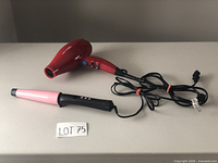 Photo showing red Conair hair dryer with cord and pink-and-black Remington curling wand next to it; both with power cords coiled.