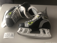 Side and top angled view of the Graf Supra S31 boys hockey skates showing black and silver design with white blades and laces.