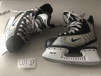Side view of boys Nike hockey skates showing the Tuuk blades and Nike swoosh on the side.