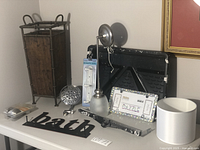 Full view of listed items including umbrella stand, light fixture, shower head, hooks, lampshades, paint pans, and license plate holder.