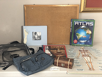 Photo showing the full lot including NASA clear backpack, blue shoulder bag, cork board, scrapbook, atlas guide, human body guide with posters, and treasure box