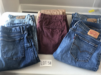 Overview of all six pairs of men's pants and jeans laid out, showing colors and styles.