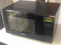 Black Panasonic microwave model NN-SG626B closed showing front and digital control panel displaying 8:8:8.