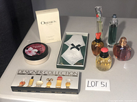 Full layout of perfumes, handkerchiefs in box, mini eau de toilette collection, and Calvin Klein Obsession box shown