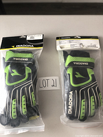 Two pairs of new black and green Diadora soccer goalie gloves in original packaging, adult size 9.