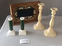 Photo showing all items including two beige tall metal candlestick holders, two green and white ceramic Hallmark candlestick holders, and rectangular wooden tray with floral design.
